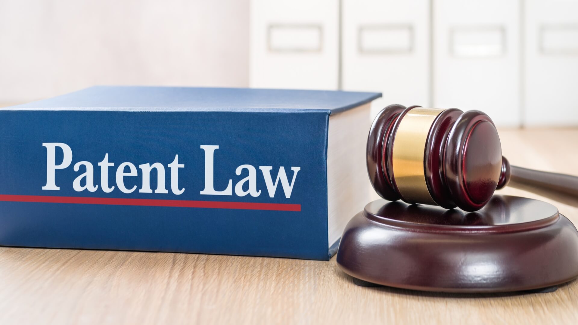 Patent law book next to a legal gavel