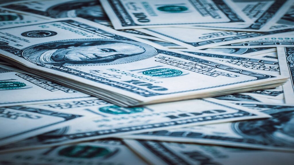 An image of stacks of 100 dollar bills