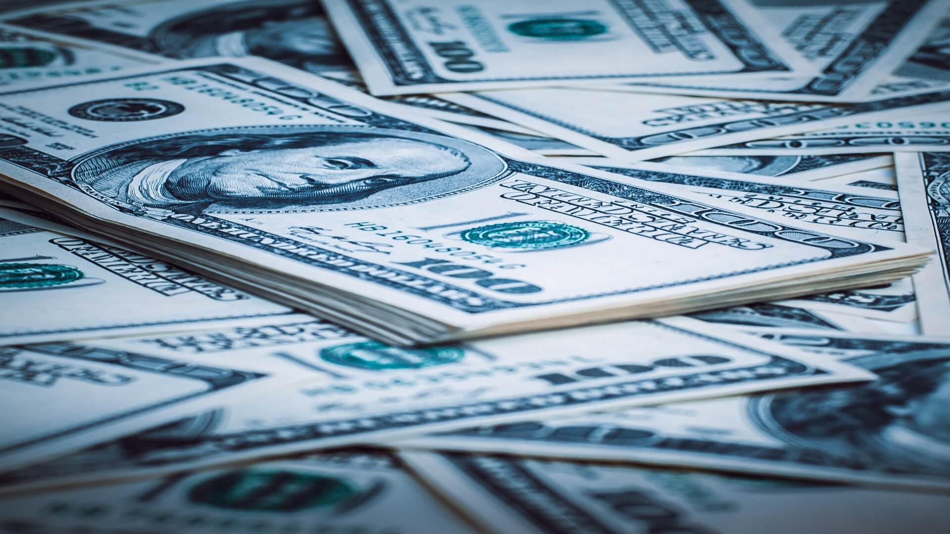 An image of stacks of 100 dollar bills