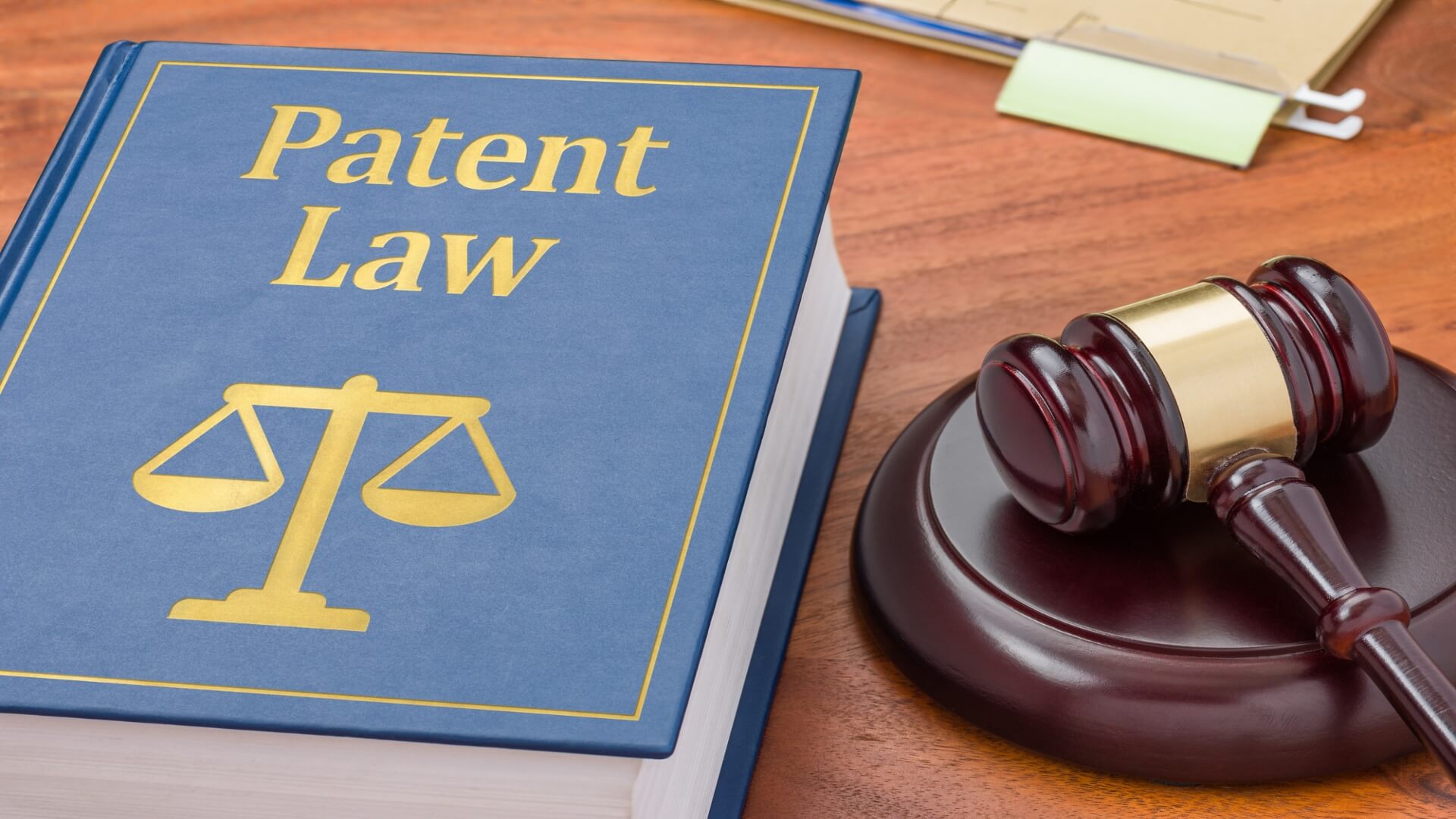 Patent law book and gavel on a desk