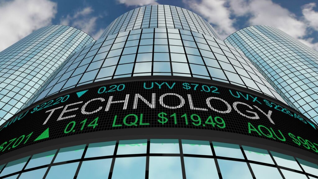 A Technology stock ticker in front of a tall Wall Street building