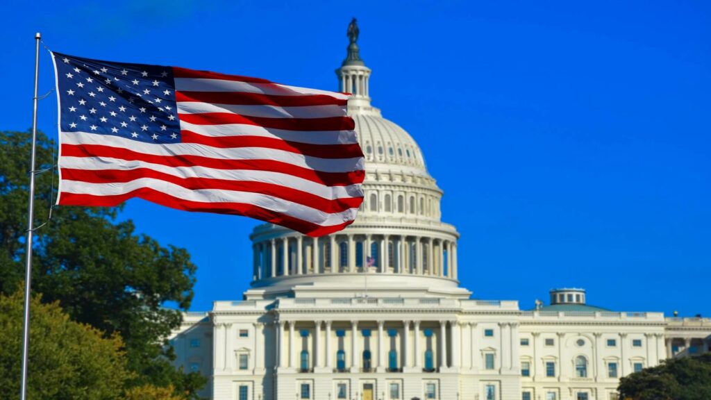Waving USA flag in front of Capitol building
