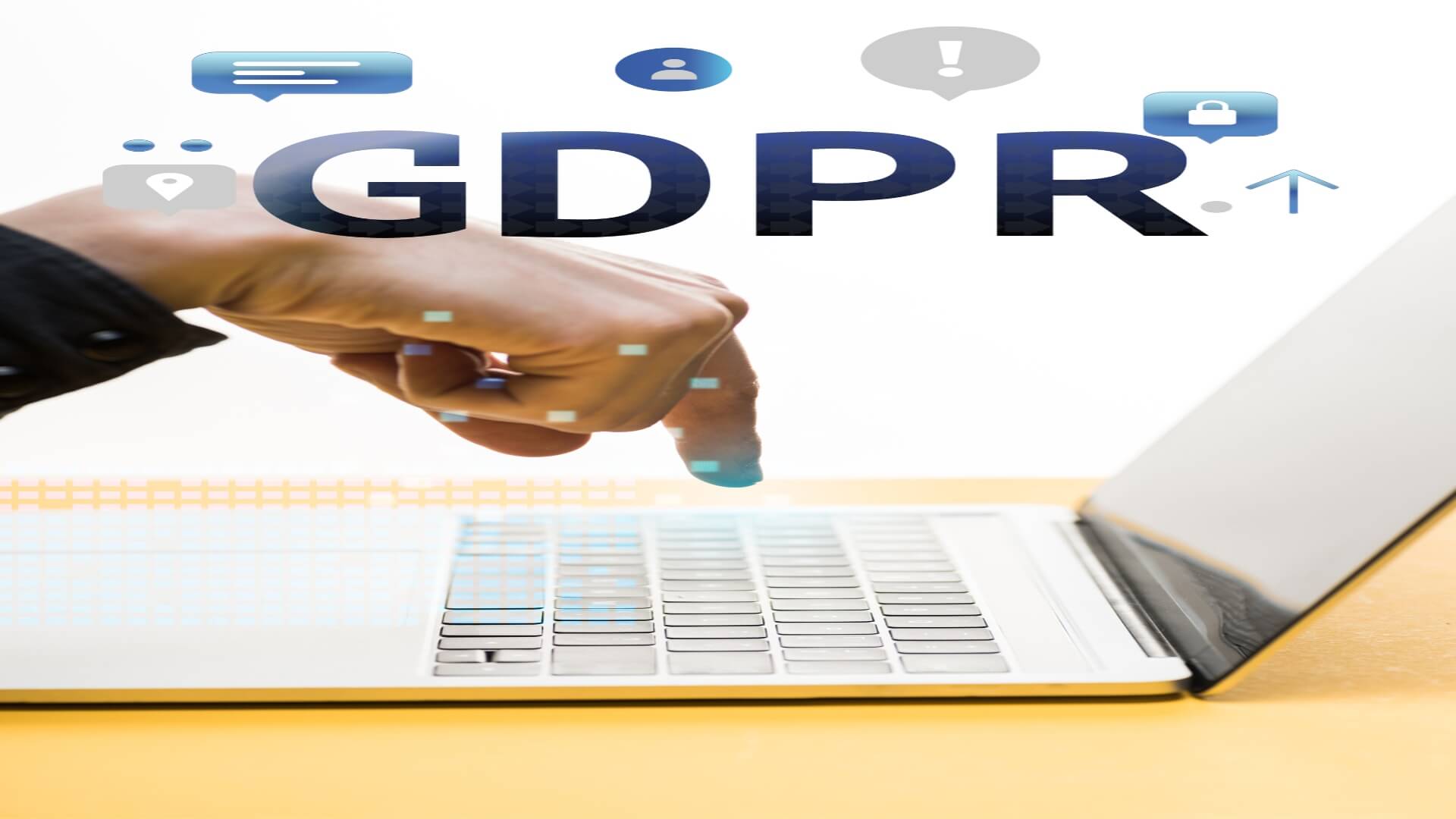 Man's finger pointing to a laptop with the letters GDPR