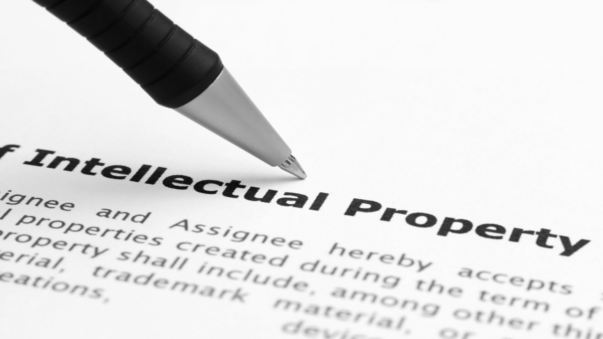 A document with a title of Intellectual Property and a ball point pen